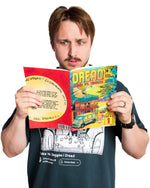 Man holding a colorful book titled 'Dread' against a white background