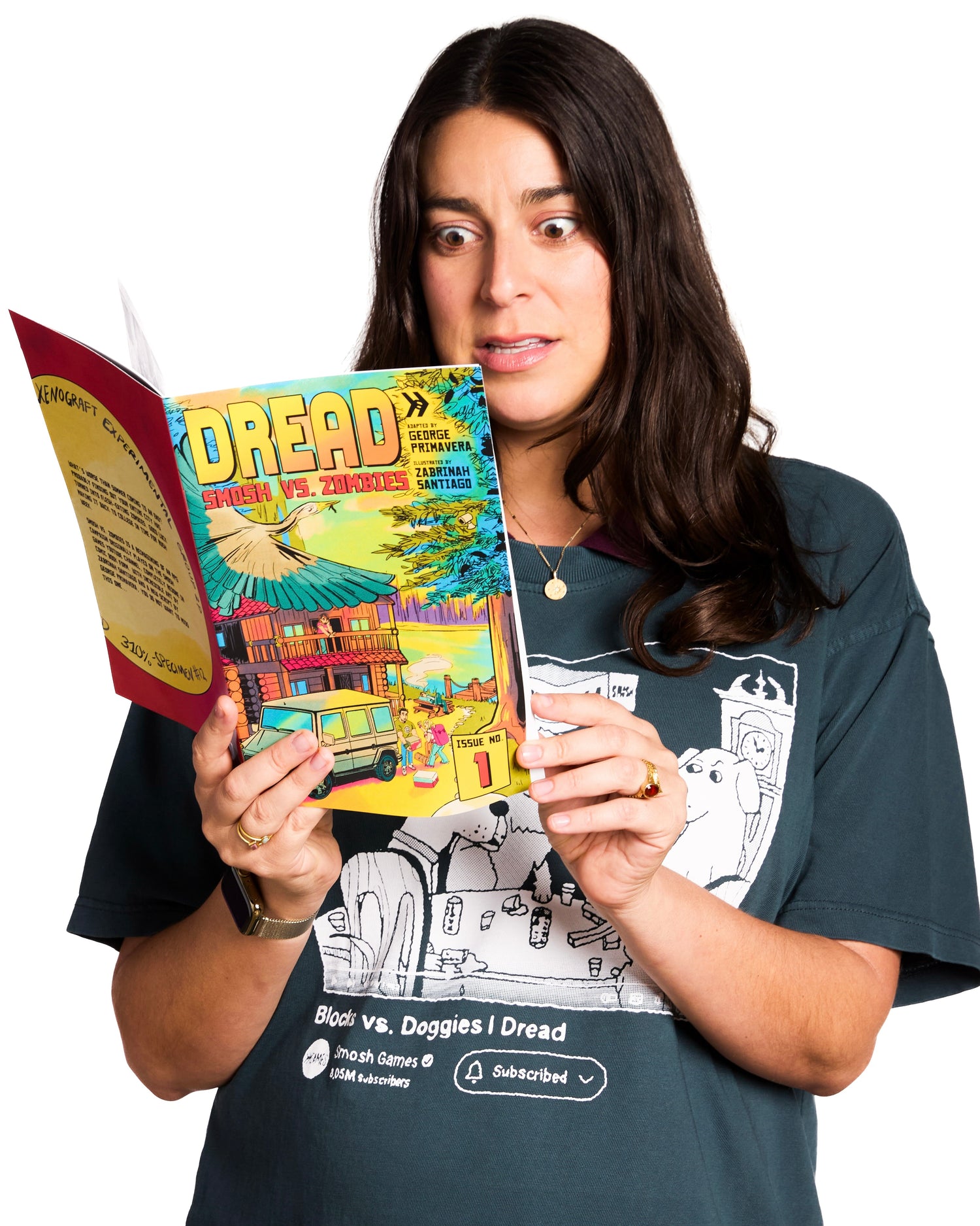 Woman holding a book titled 'Dread' while wearing a t-shirt with graphic designs.
