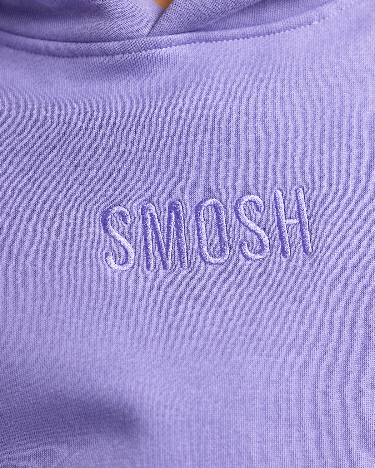 Close-up of a purple hoodie with 'Smosh' embroidered on it.