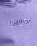 Close-up of a purple hoodie with 'Smosh' embroidered on it.