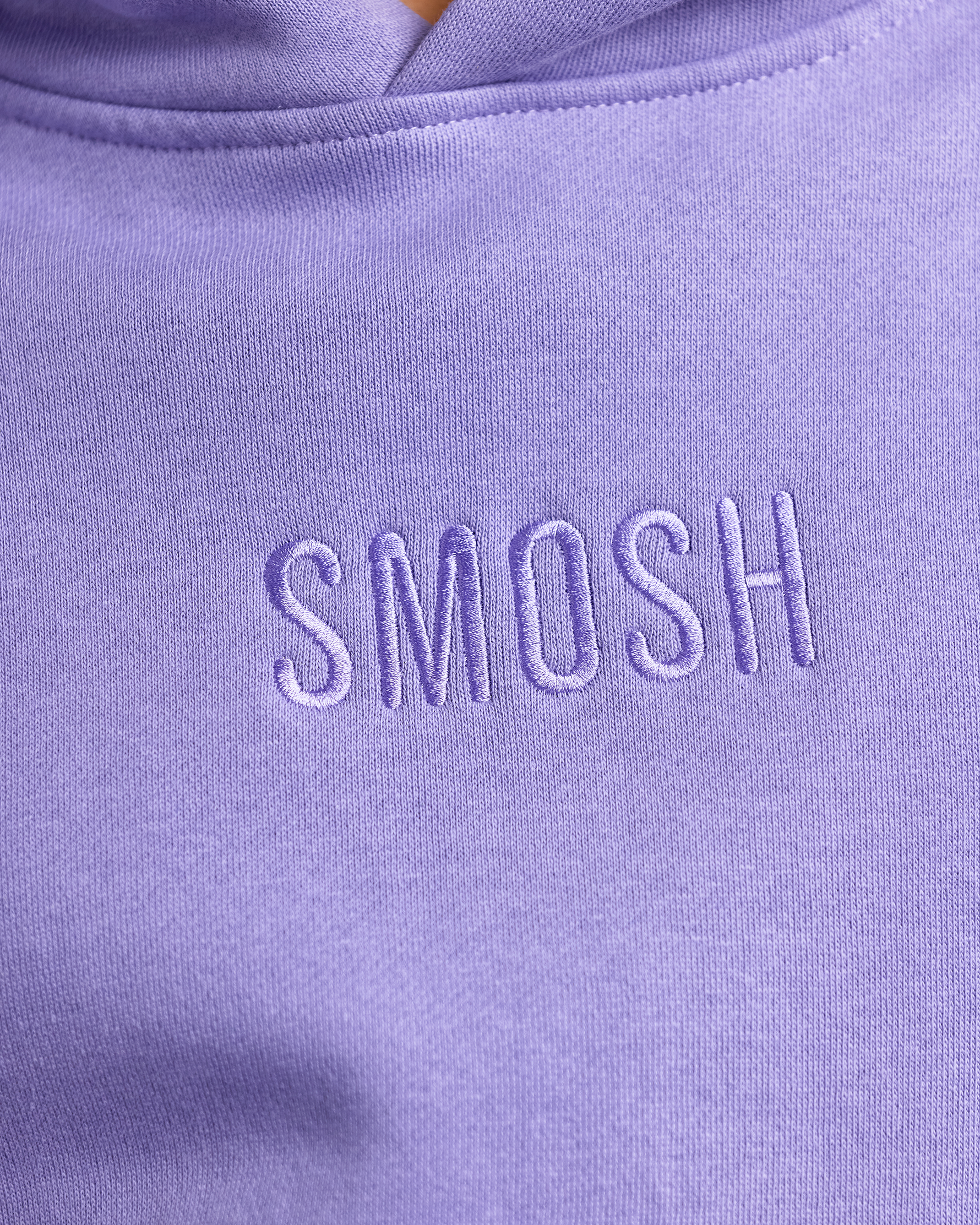 Close-up of a purple hoodie with 'Smosh' embroidered on it.