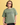 Person wearing a green 'Smosh' t-shirt against a yellow background