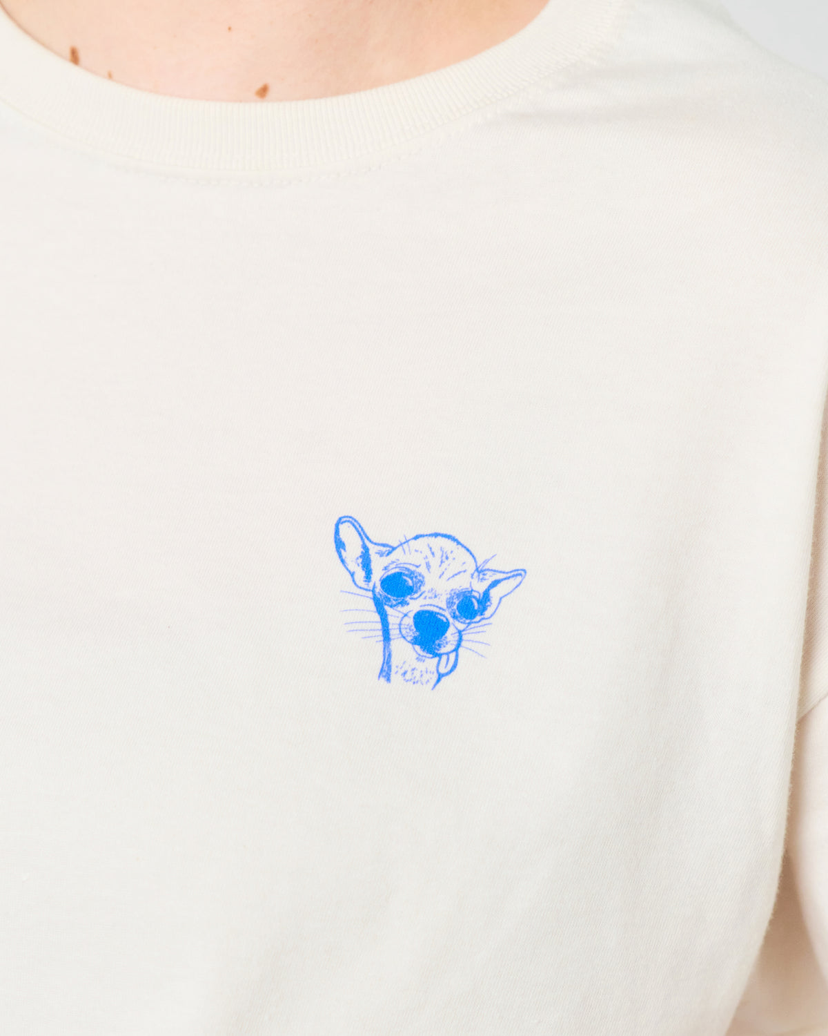 White t-shirt with a blue graphic of a dog wearing sunglasses on a white background