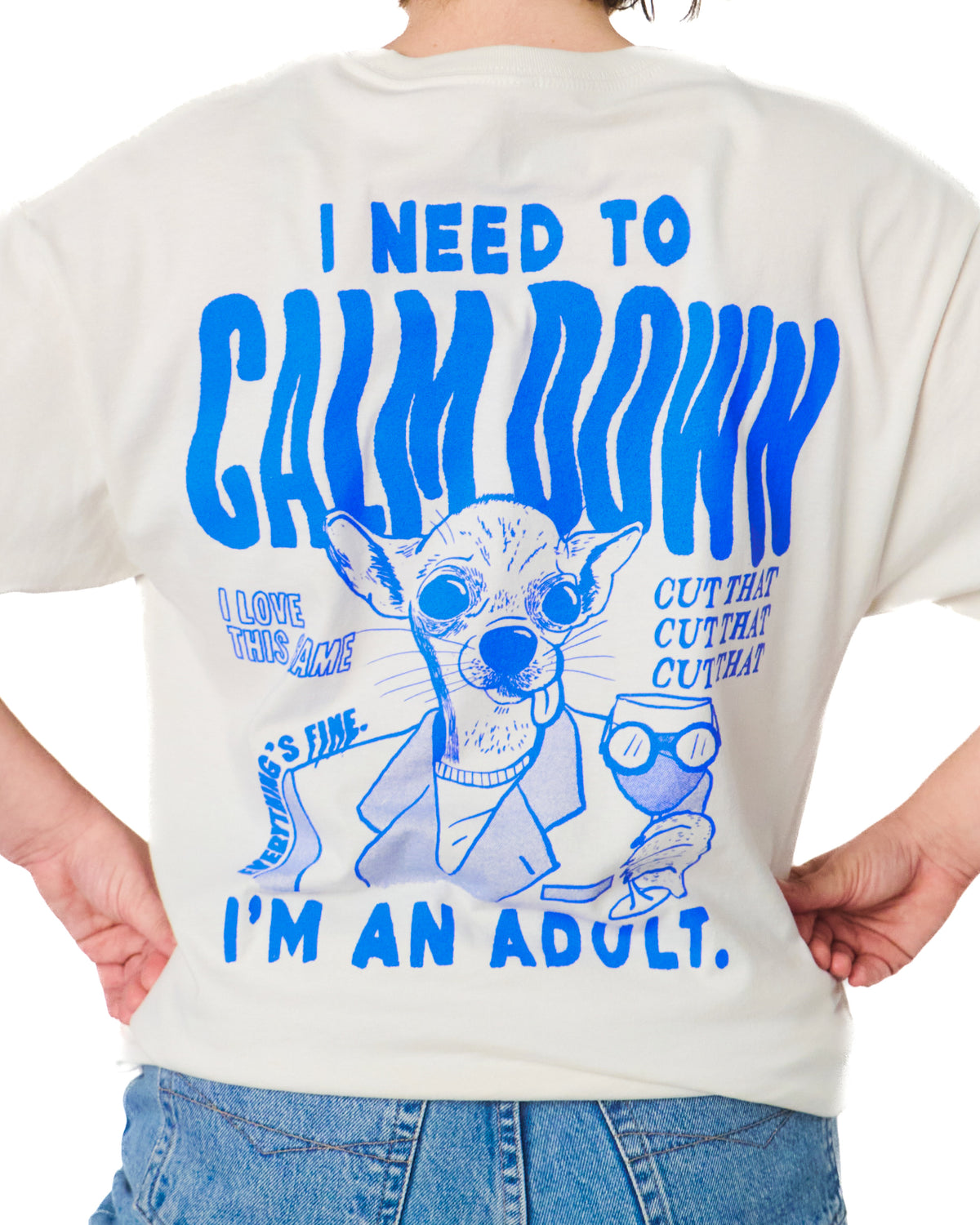 White t-shirt with blue graphic and text on the back, worn by a person.
