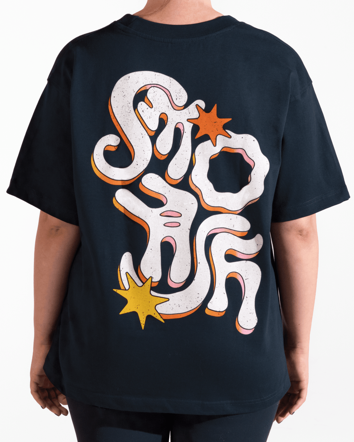 model wearing navy tshirt with funky multicolor smosh design on back on a white background