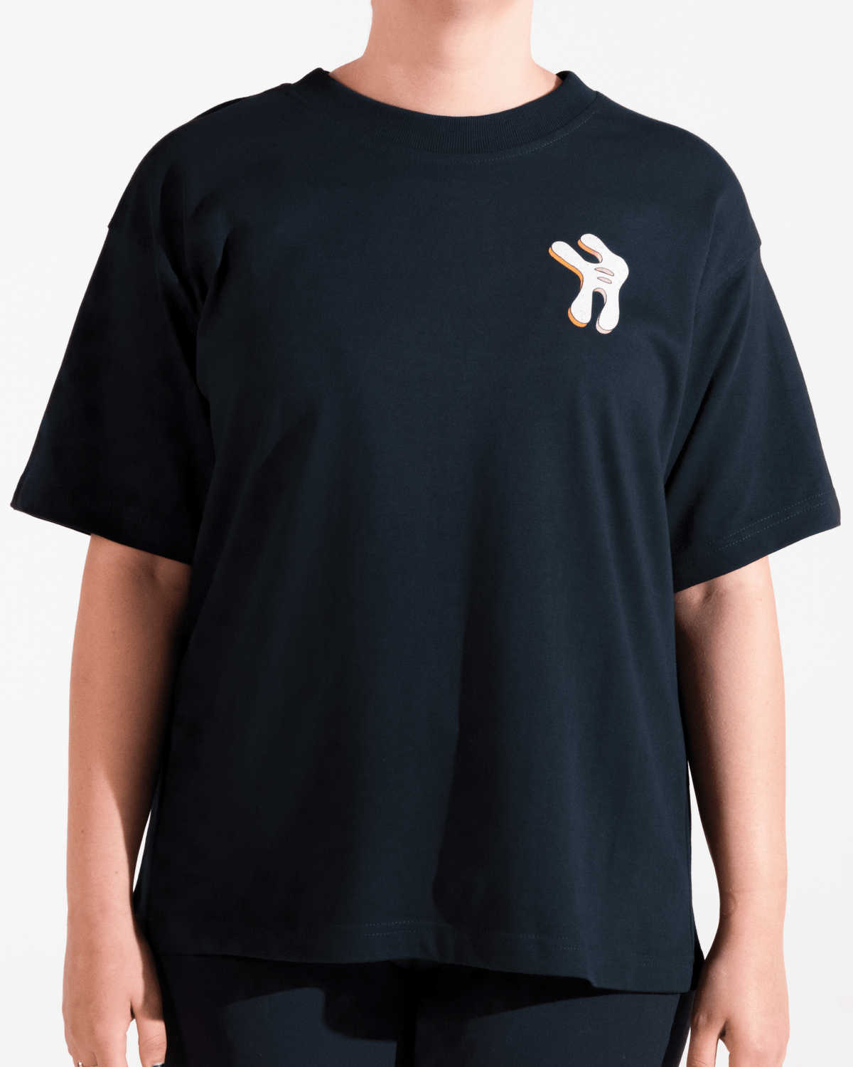 model wearing navy tshirt with funky multicolor smosh design on chest on a white background