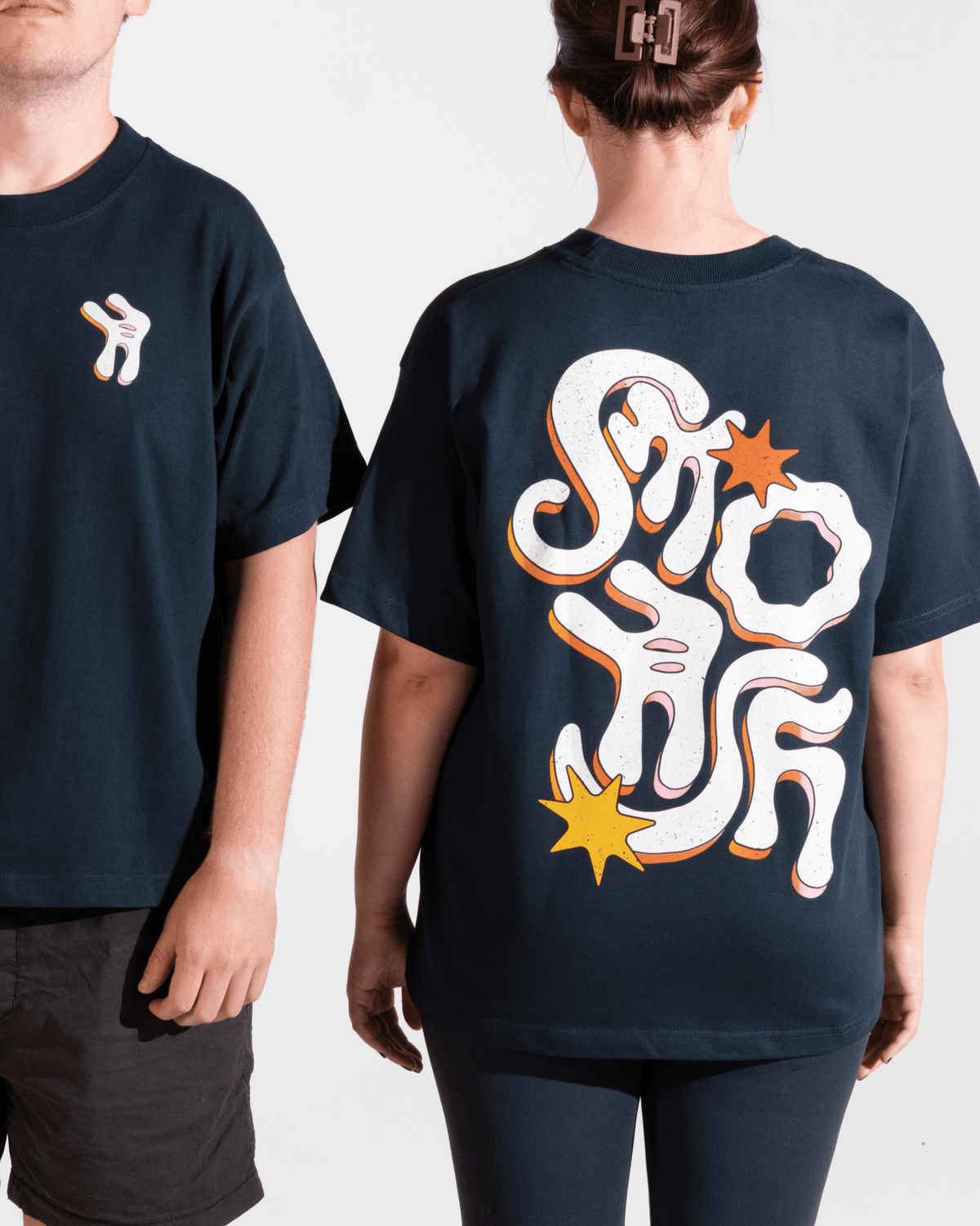 two models wearing navy tshirt with funky multicolor smosh design on back and front on a white background