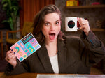 woman holding colorful sticker sheet with bitcity mug