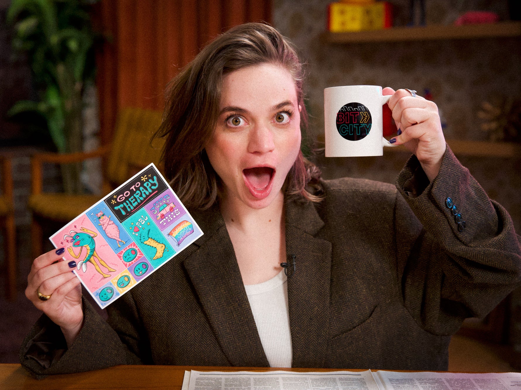 woman holding colorful sticker sheet with bitcity mug