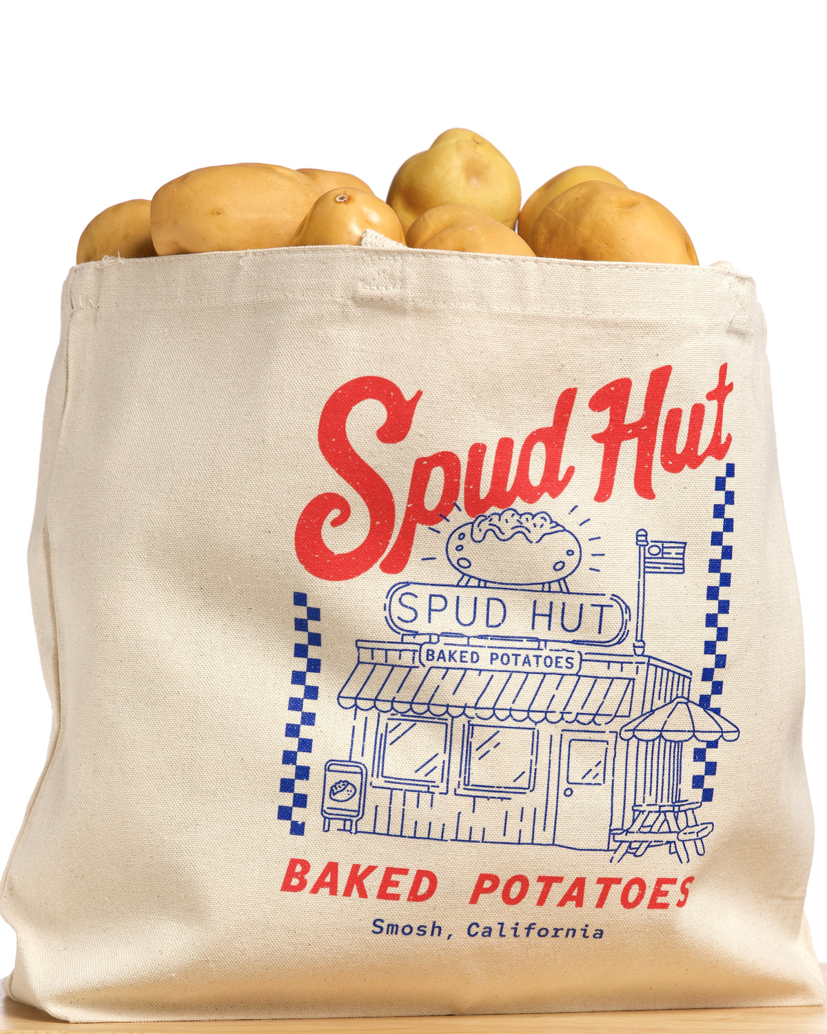 Spud Hut tote bag with potatoes on a white background