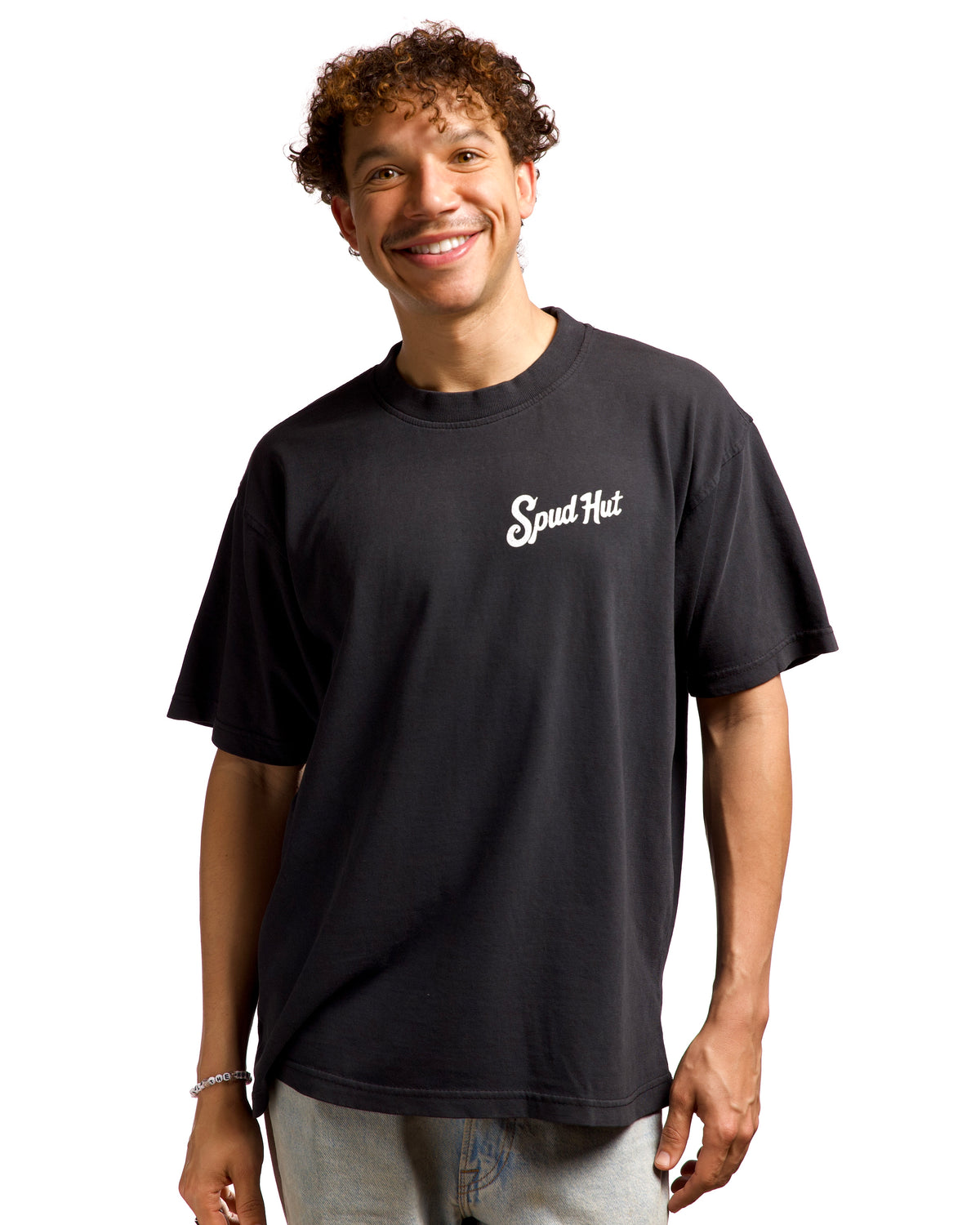 Man wearing a black t-shirt with 'Spud Hat' logo on a white background