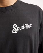 woman wearing black tshirt with sput hut written on the side of the chest