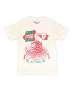 Beige t-shirt with a graphic design of pancakes and text on a white background