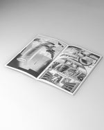 Open book with black and white illustrations on a gray background