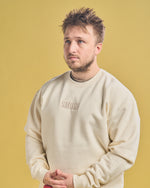 Shayne Topp wearing Cream Smosh Essentials Embroidered Crewneck