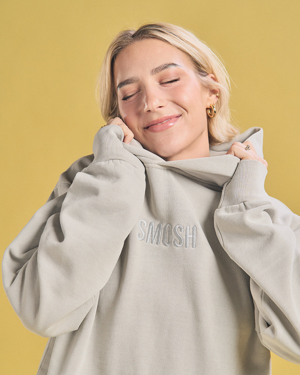 Courtney Miller in grey Smosh essentials embroidered hoodie