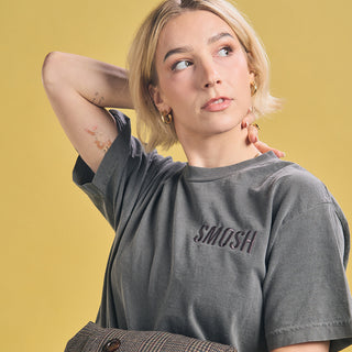 Courtney Miller in short sleeve faded black Smosh essentials embroidered tee