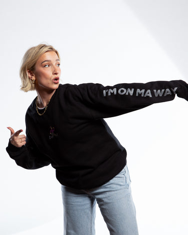 Courtney Miller wearing SMOSH black long sleeve Gerald Cakes Crewneck