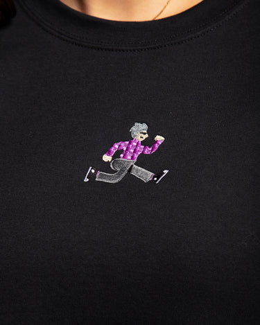 Close up embroidered logo on SMOSH black long sleeve Gerald Cakes Crewneck