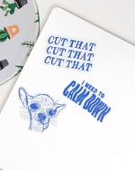 Notebook with blue text and dog illustration on a white surface
