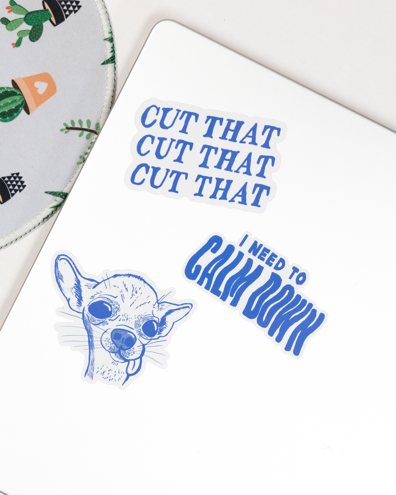 Notebook with blue text and dog illustration on a white surface