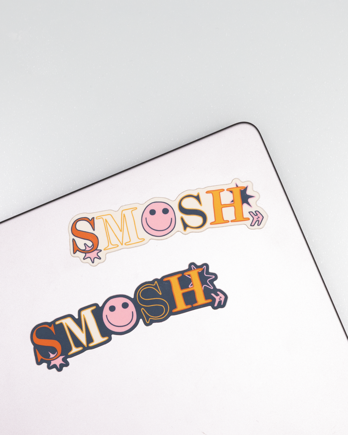multicolor smosh stickers with smiley face on a laptop