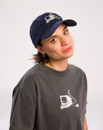 Angela Giarratana wearing smosh navy blue base ball cap with chronically offline logo