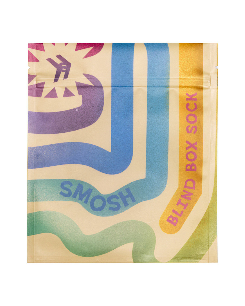 A flat, front-facing view of a resealable pouch package with a retro wavy pattern in cream, blue, purple, yellow, and green. The package includes the text 'SMOSH' and 'BLIND BOX SOCK' and shows a small logo in the upper left.